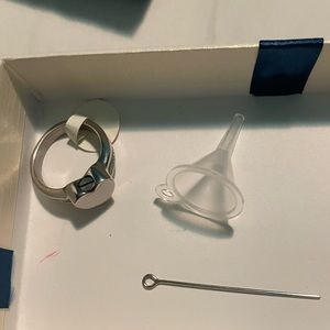 Stained silver heart ring. You put ashes of a loved one in the ring.